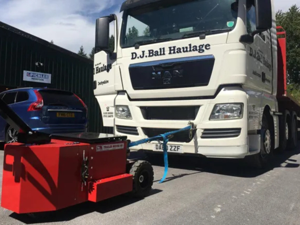 Heavy-Duty Trailer Mover operating inside a warehouse facility